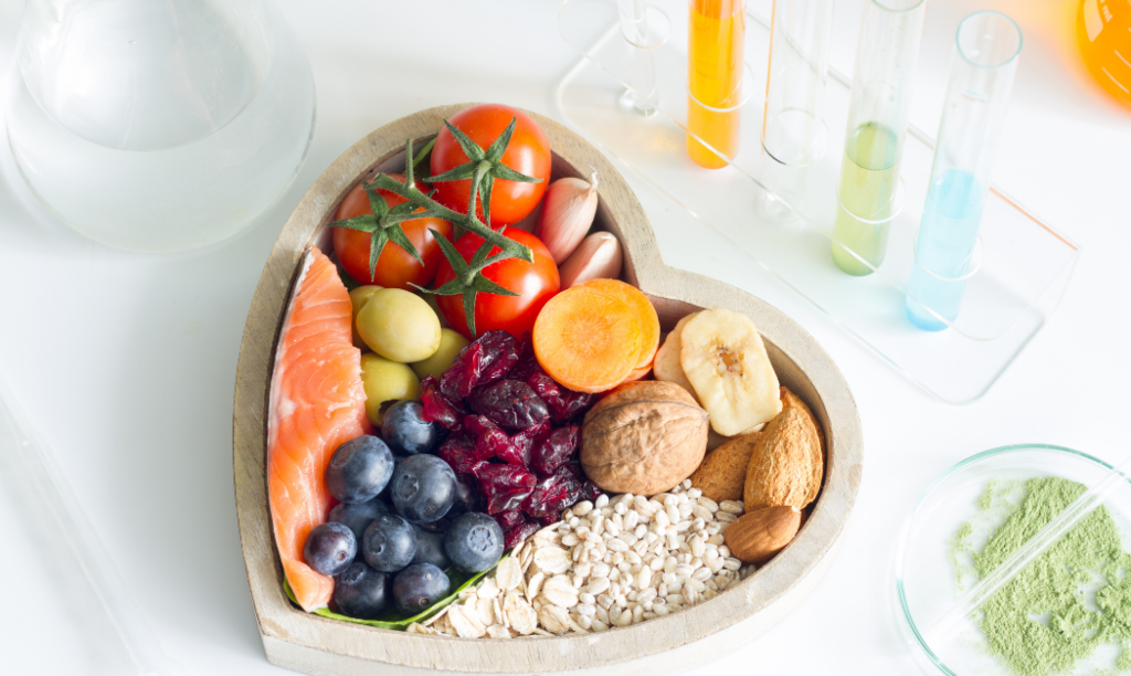 Foods for white teeth and a brighter smile. Heart-shaped bowl with salmon, blueberries, tomatoes, nuts, and grains, plus lab beakers.