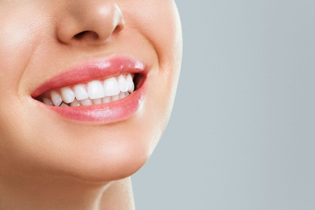 Smiling woman showing white teeth. Considering how often to whiten teeth for optimal dental health and a brighter smile.